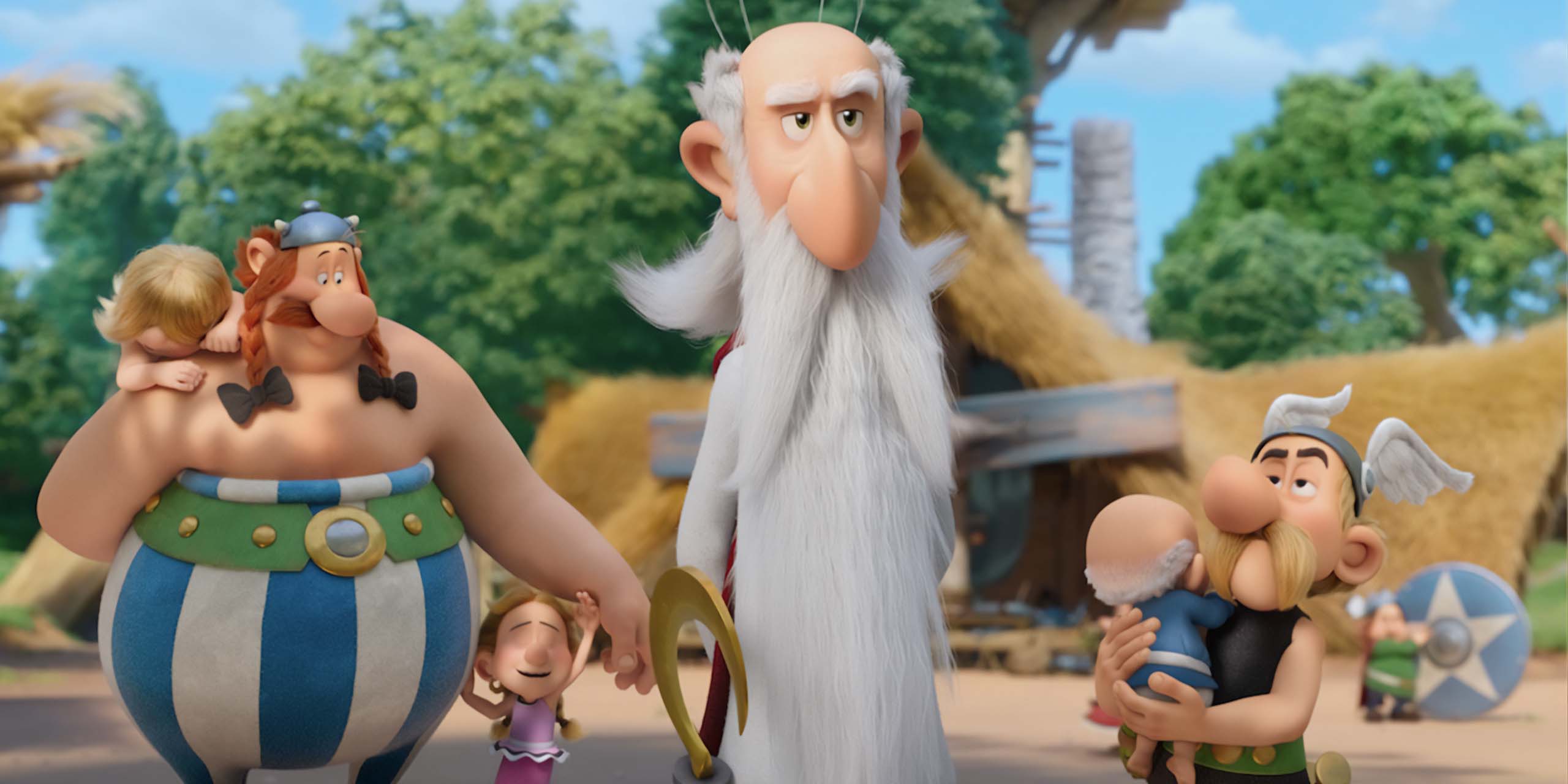 Astérix tenant Agecanonix bébé, Obélix et Panoramix, tandis que les villageois sont tous redevenus enfants, dans Astérix : Le Royaume de Nubie.