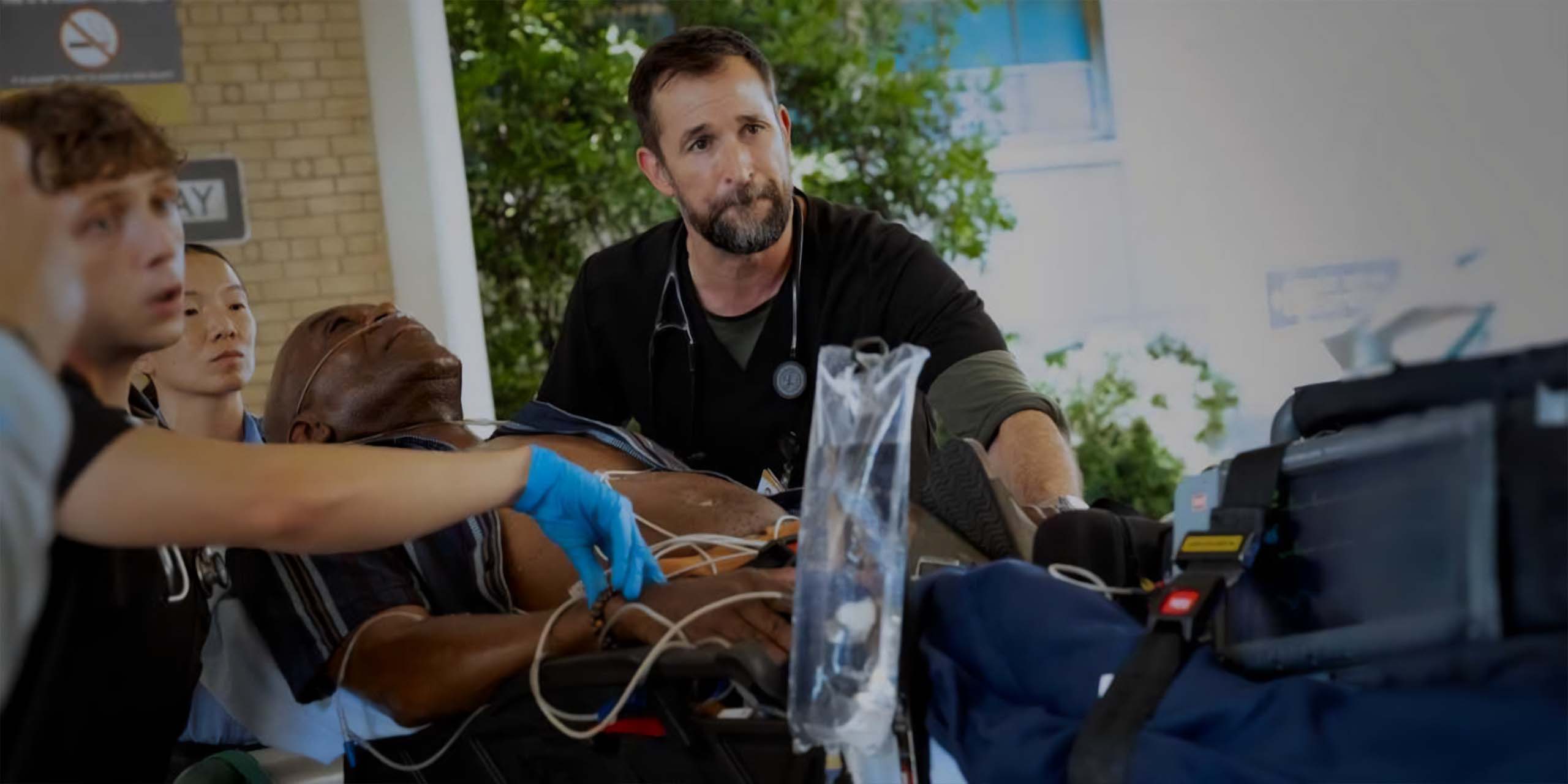 Dennis Whitaker (Gerran Howell) et le Dr Michael Robinavitch (Noah Wyle) aident un patient à l'hôpital The Pitt.