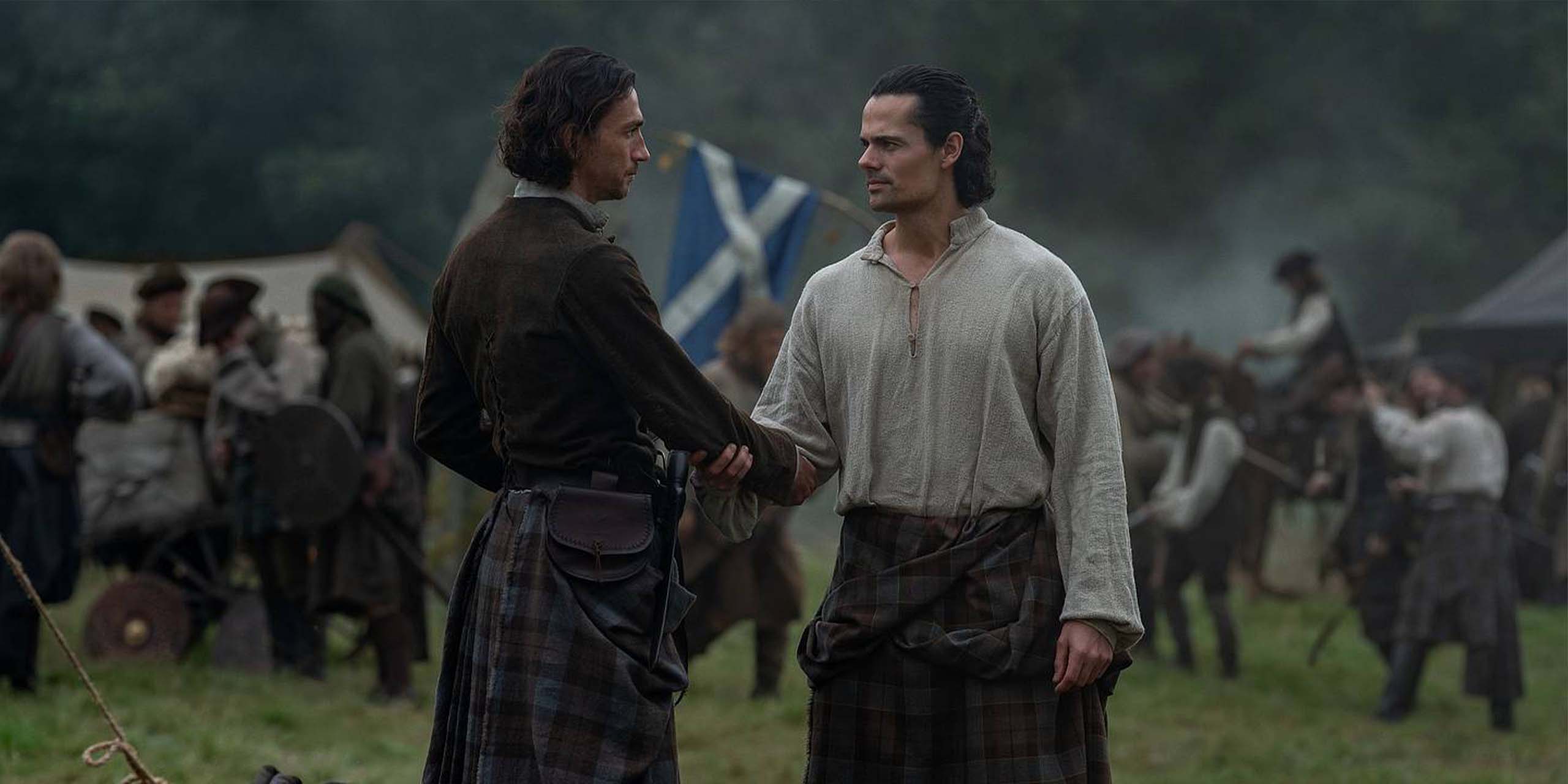 Rory Alexander (Murtagh Fraser) et Jamie Roy (Brian Fraser) se serrent la main sur le champ de bataille dans la saison 2 d'Outlander : Blood of My Blood.